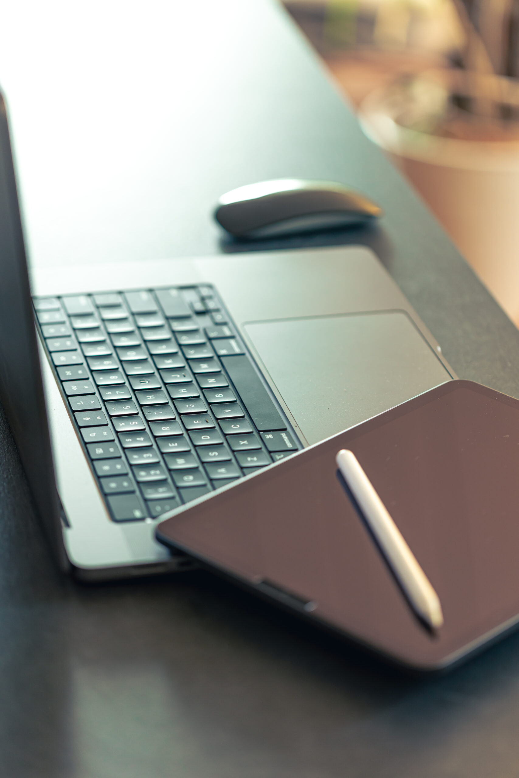 digital tablet, stylus pen and laptop on the desktop, close up.